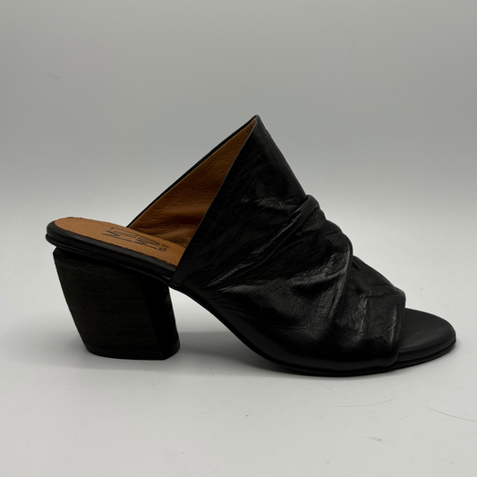 Right facing view of a slouchy black leather sandal with a 2 inch heel