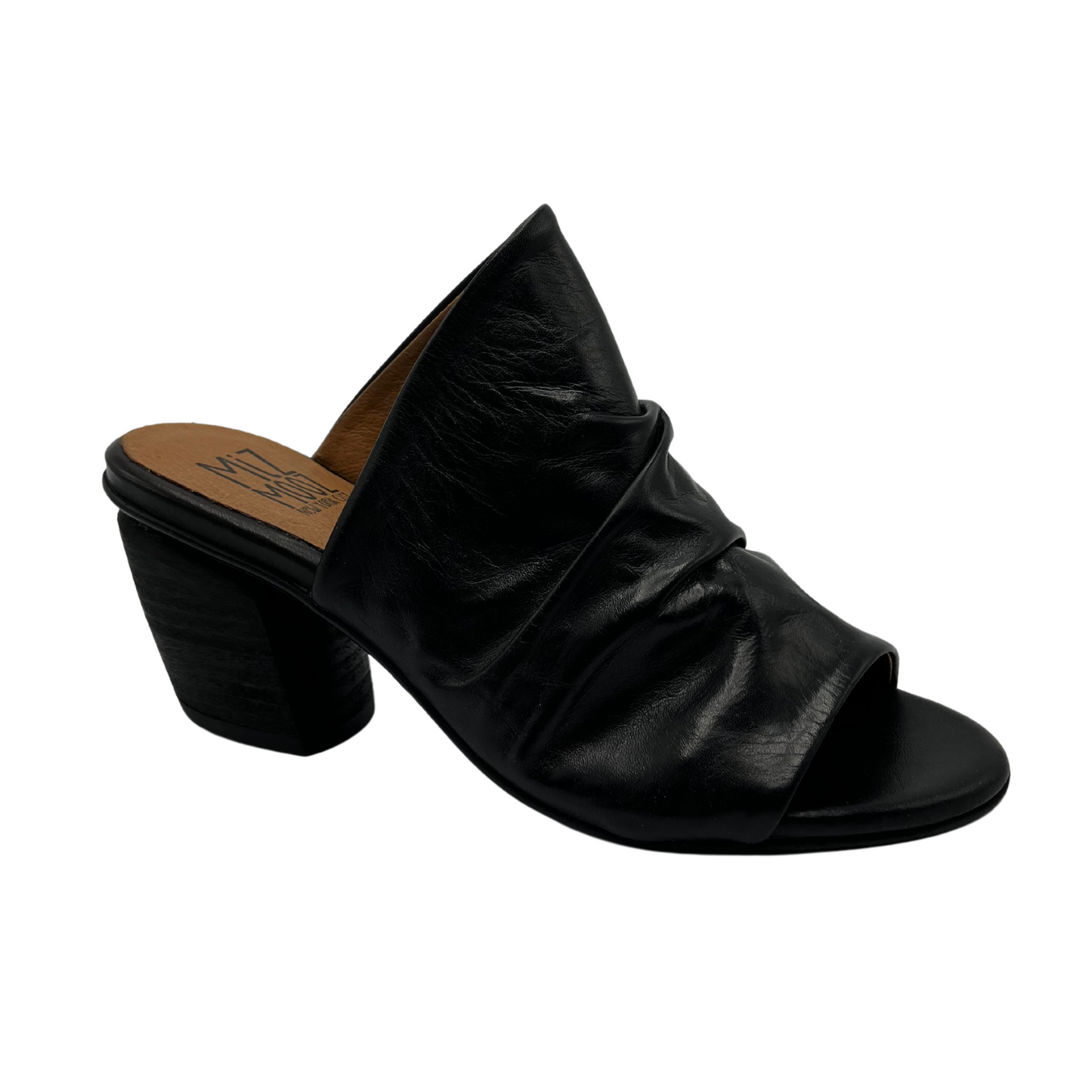 45 degree angled view of slouchy leather sandal in black. With a muled heel and open toe.