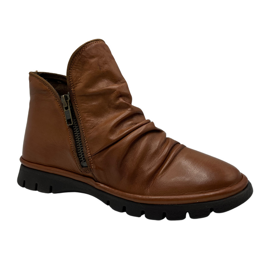 45 degree angled view of brown leather ankle boot with slouchy upper, double side zipper closures and slim rubber outsole