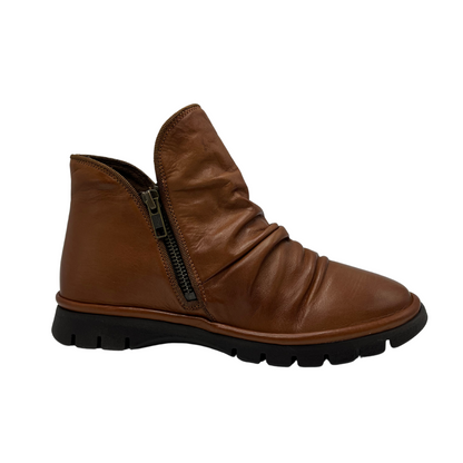 Right facing view of brown leather ankle boot with slouchy upper, double side zipper closures and slim rubber outsole