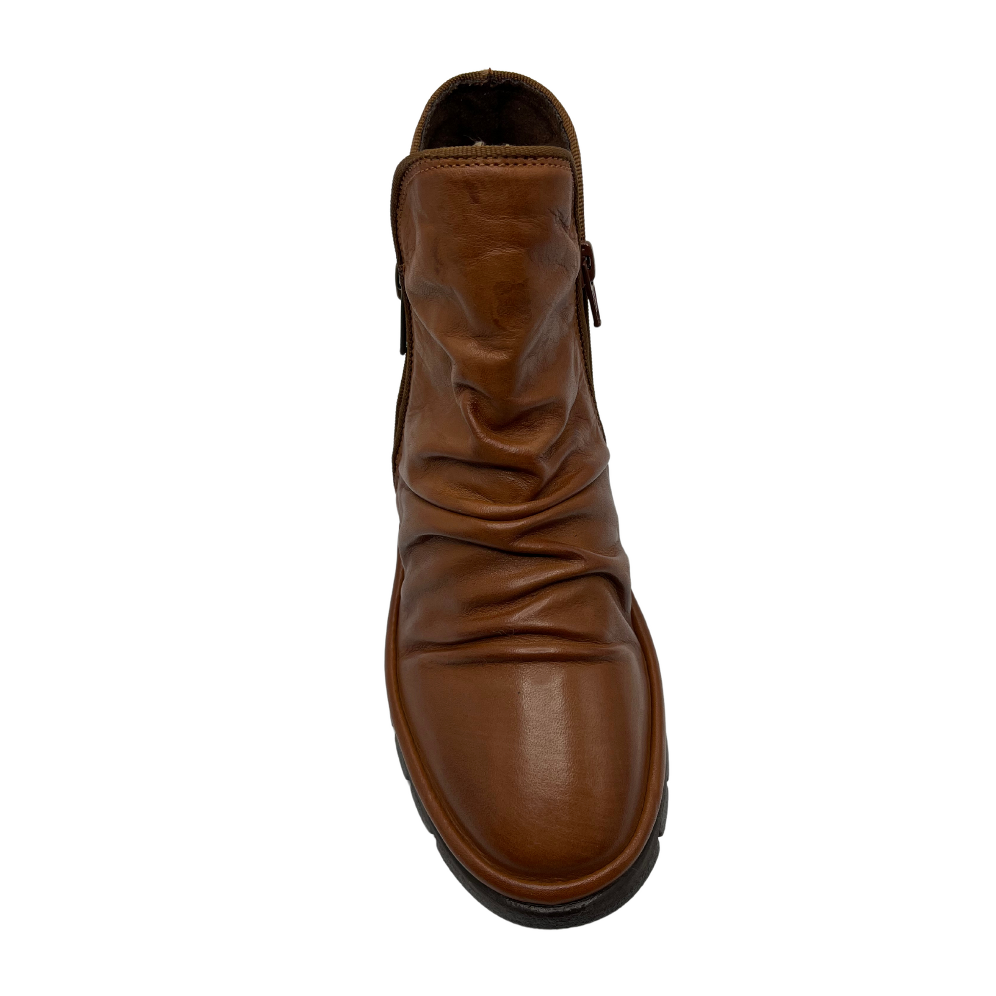 Top view of brown leather ankle boot with slouchy upper, double side zipper closures and slim rubber outsole