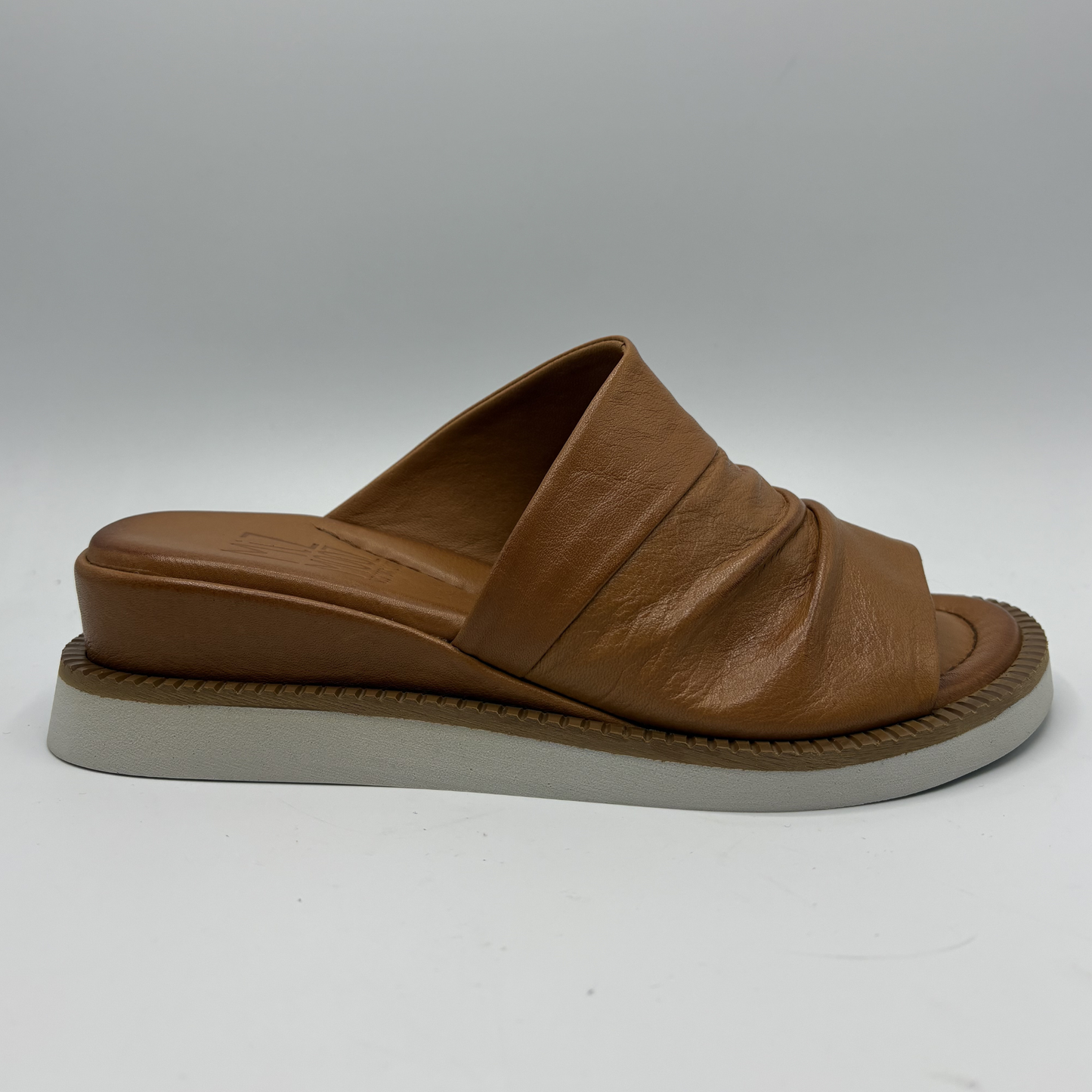Brown sandal with a thick sole on a white background