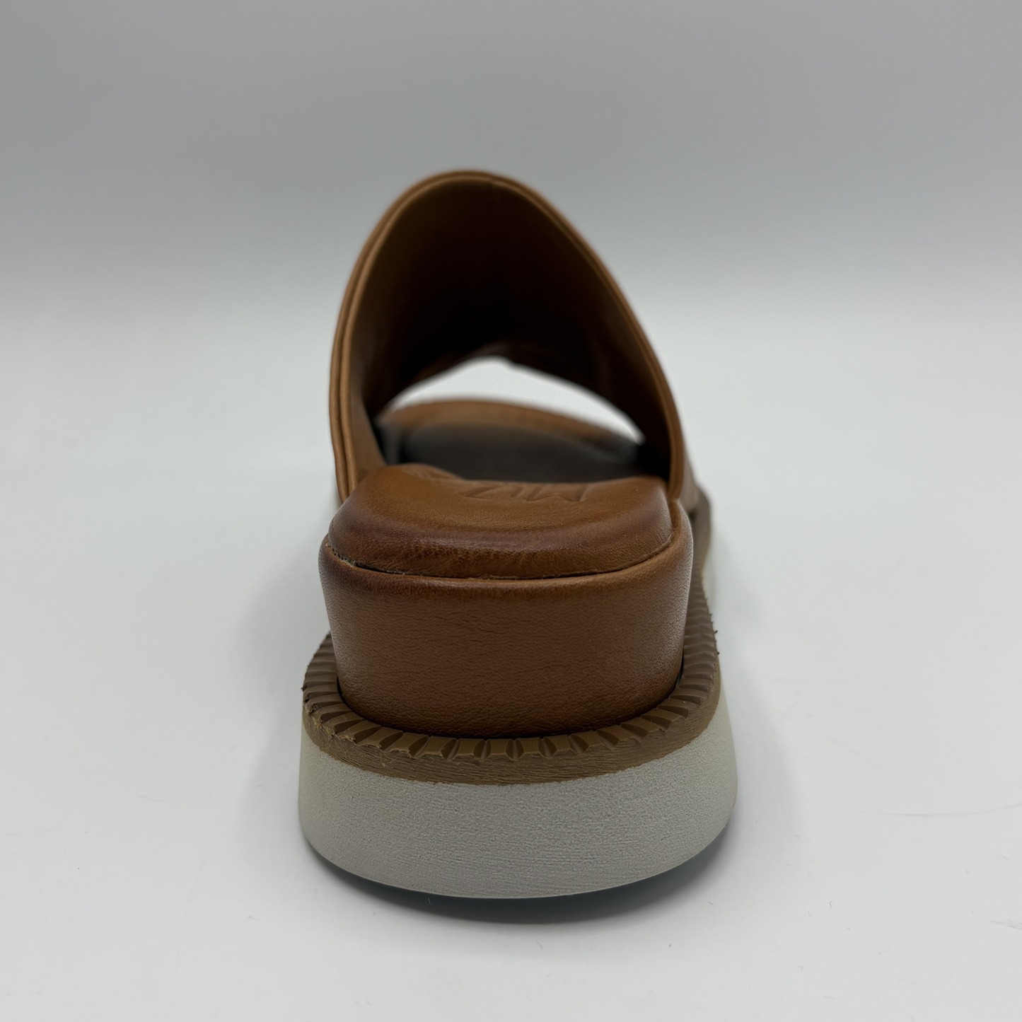 Brown sandal with a thick sole on a white background