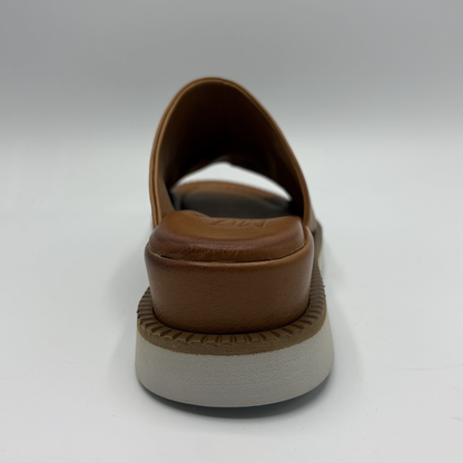 Brown sandal with a thick sole on a white background
