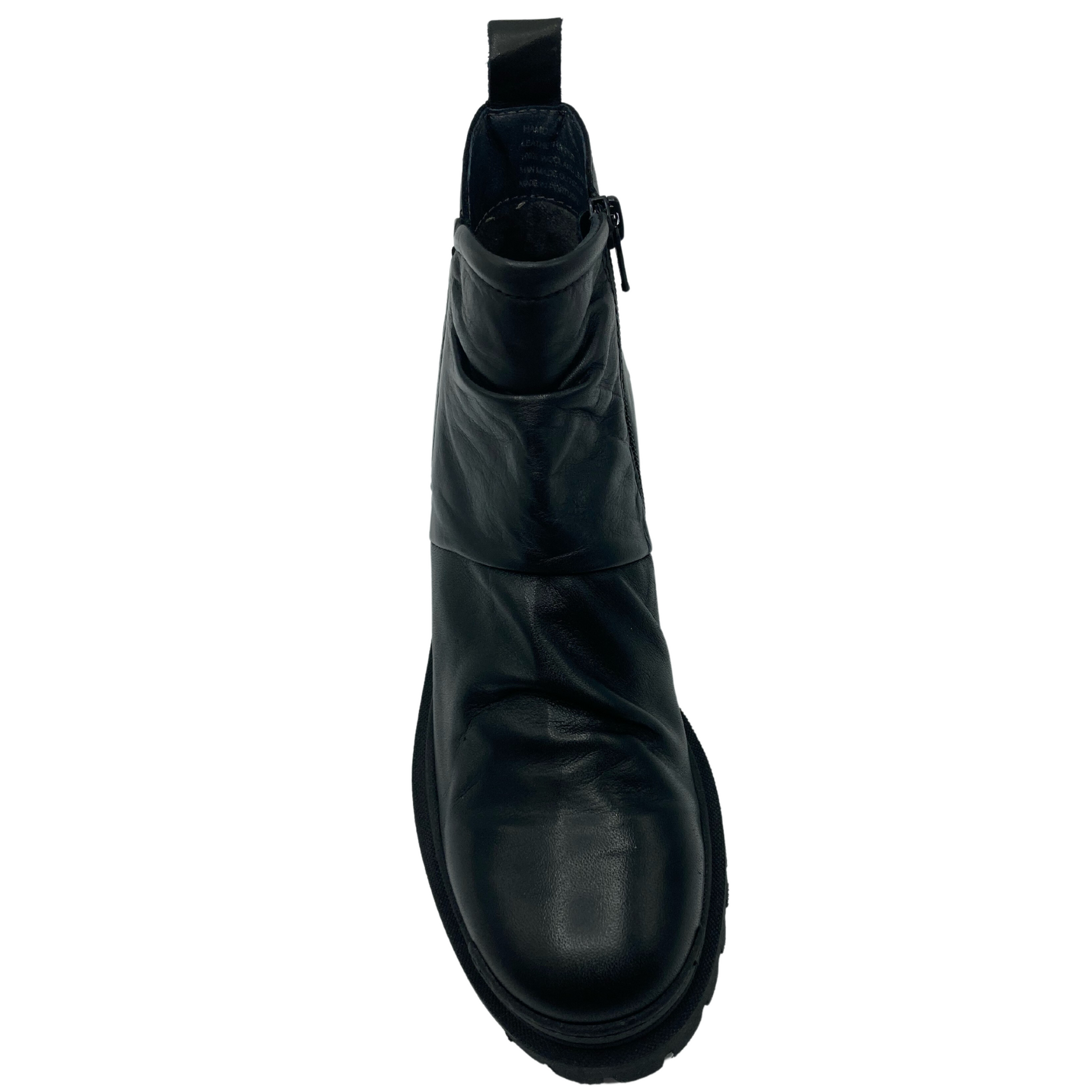 Top view of black leather boot with rounded toe and chunky rubber sole