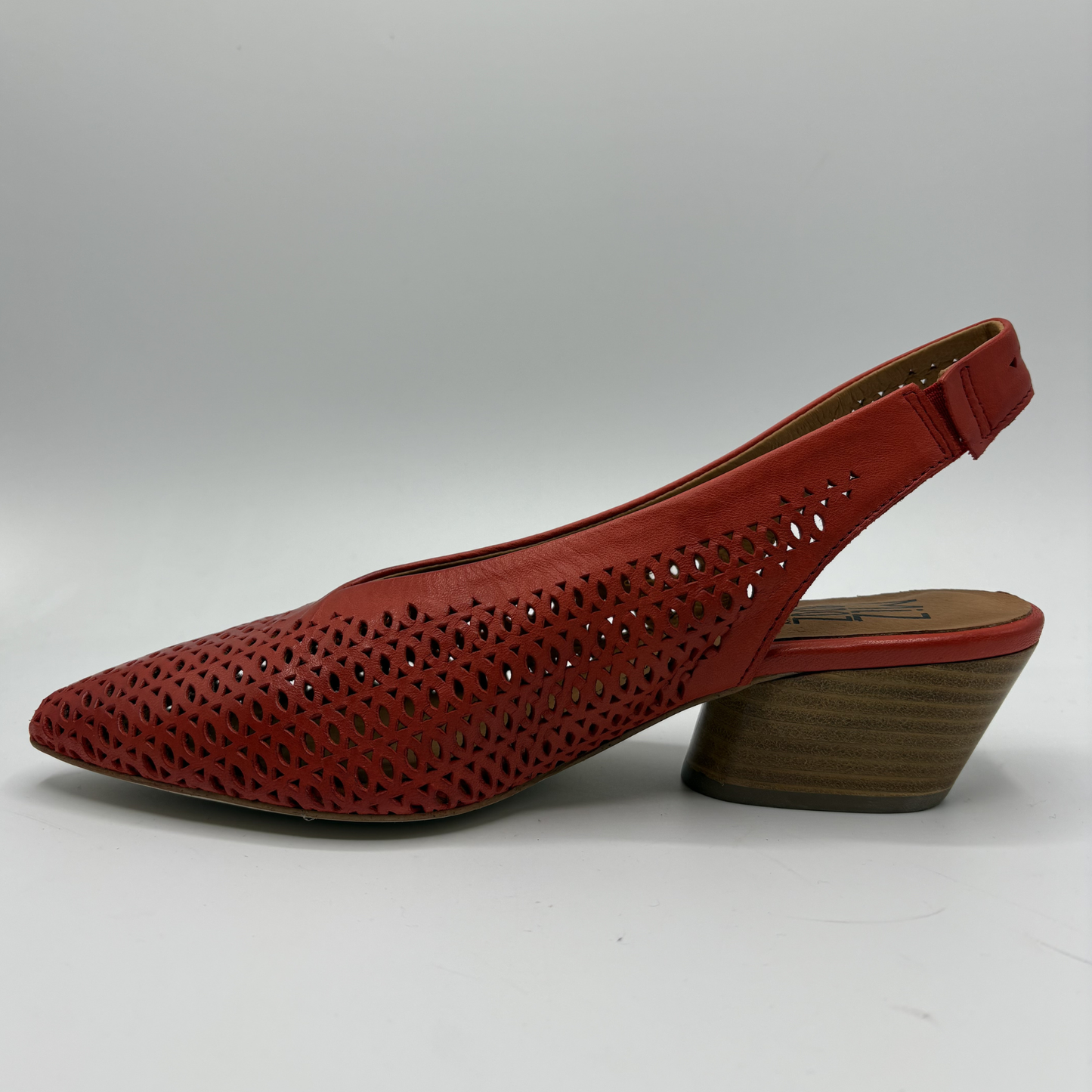 Red perforated shoe on a white background