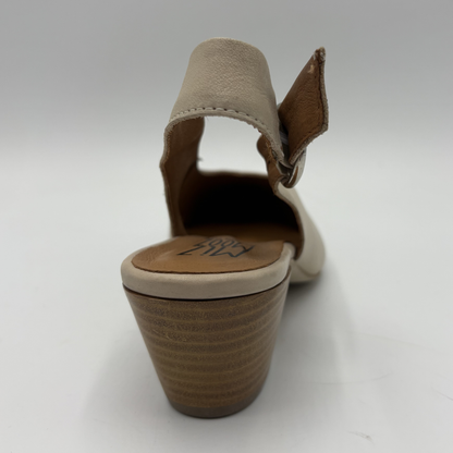 Beige sandal with a brown sole on a white background