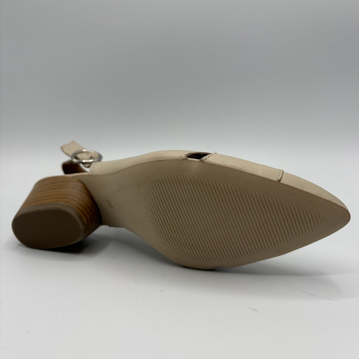 Close-up of a beige shoe sole on a white background