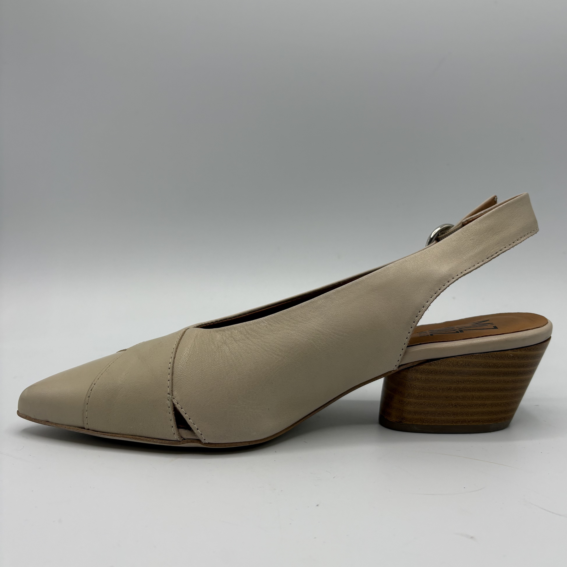 Beige slingback shoe on a white background