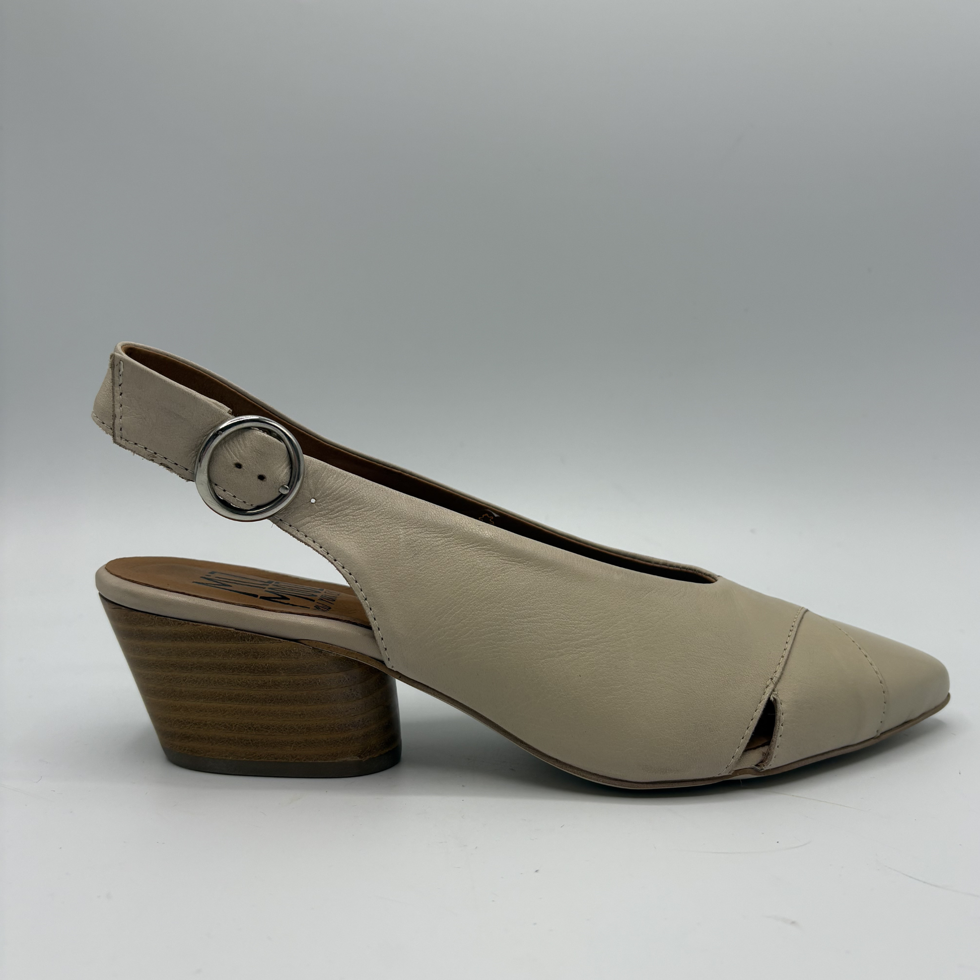 Beige shoe with a brown heel on a gray background