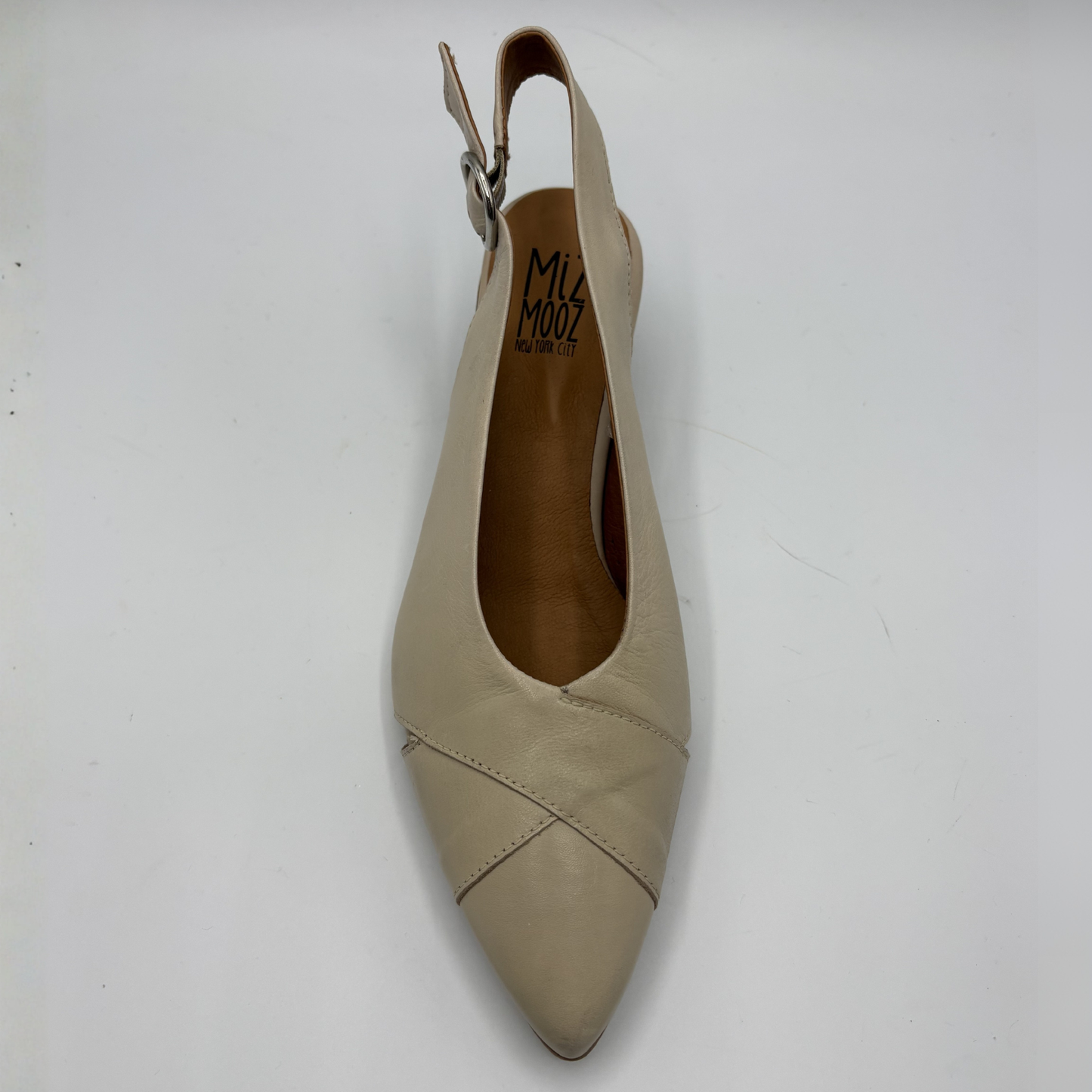 Beige slingback shoe on a white background
