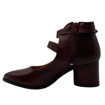 Left facing view of wine coloured leather shoe with block heel, side zipper closure and pointed toe