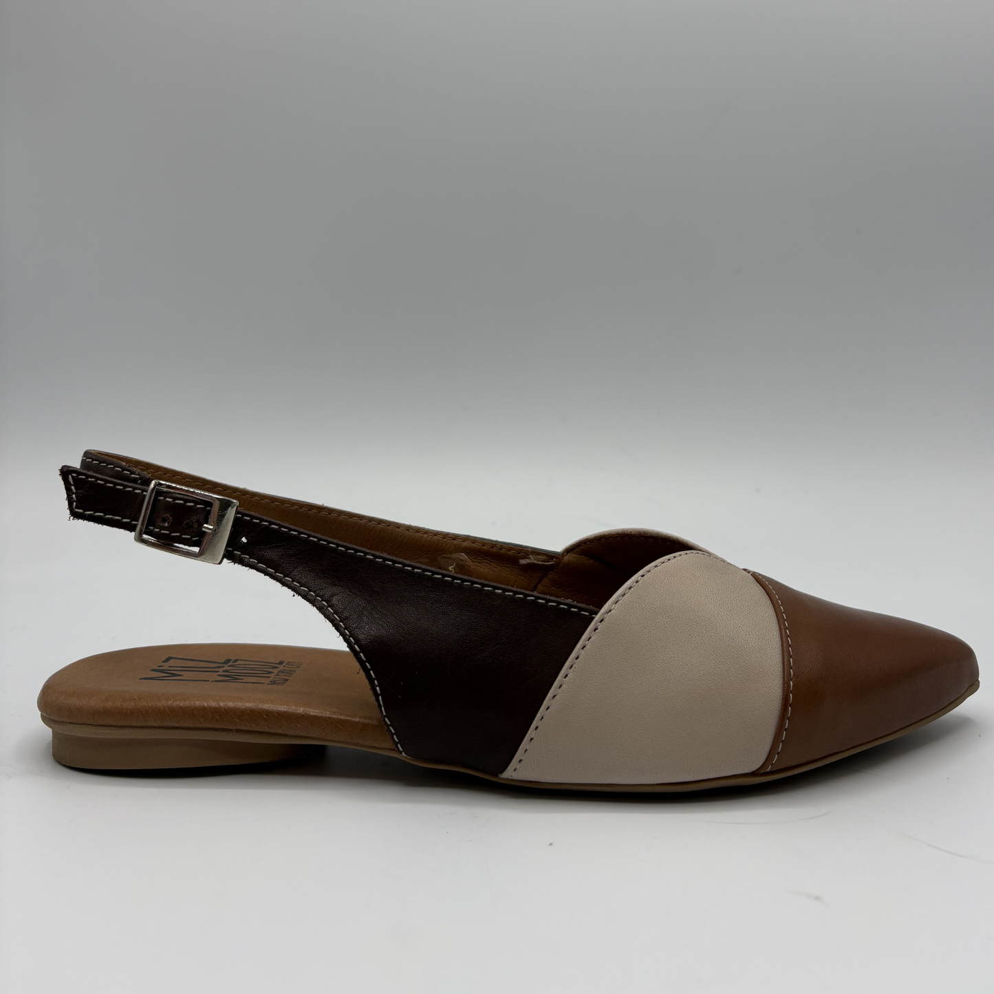 Brown and beige sandal with a buckle on a white background