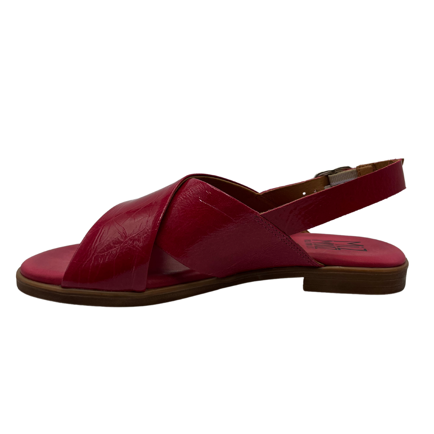 Left facing view of fuchsia leather flat sandal with low heel, buckle sling back strap and open toe