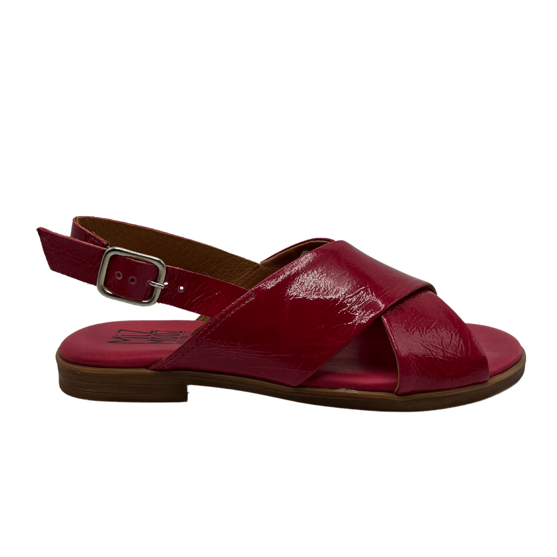 Right facing view of fuchsia leather flat sandal with low heel, buckle sling back strap and open toe