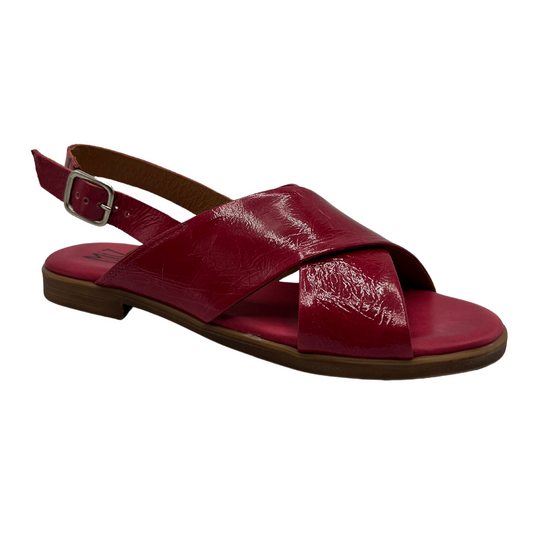 45 degree angled view of fuchsia leather flat sandal with low heel, buckle sling back strap and open toe