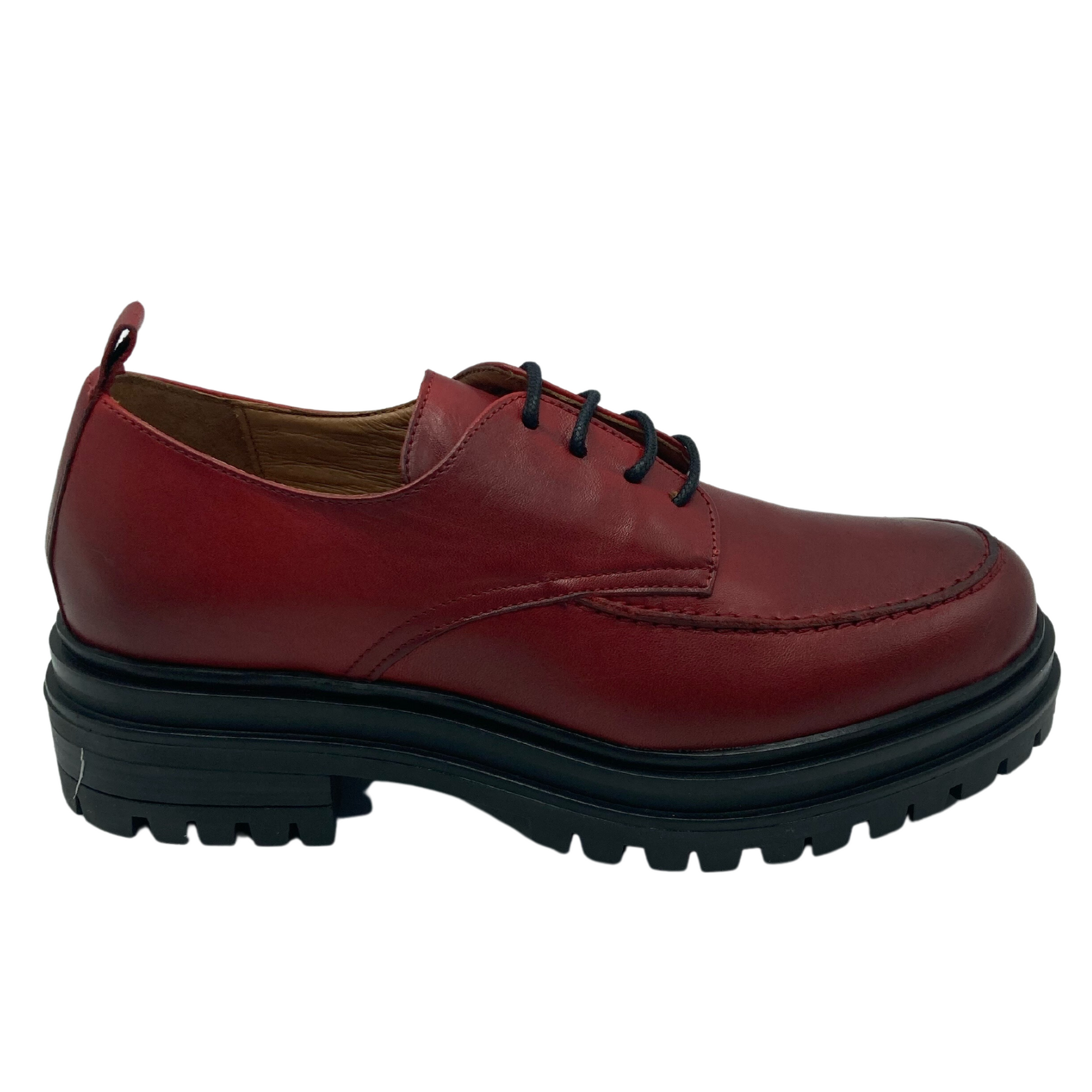 Right facing view of red leather loafer with tan insole and black chunky rubber sole