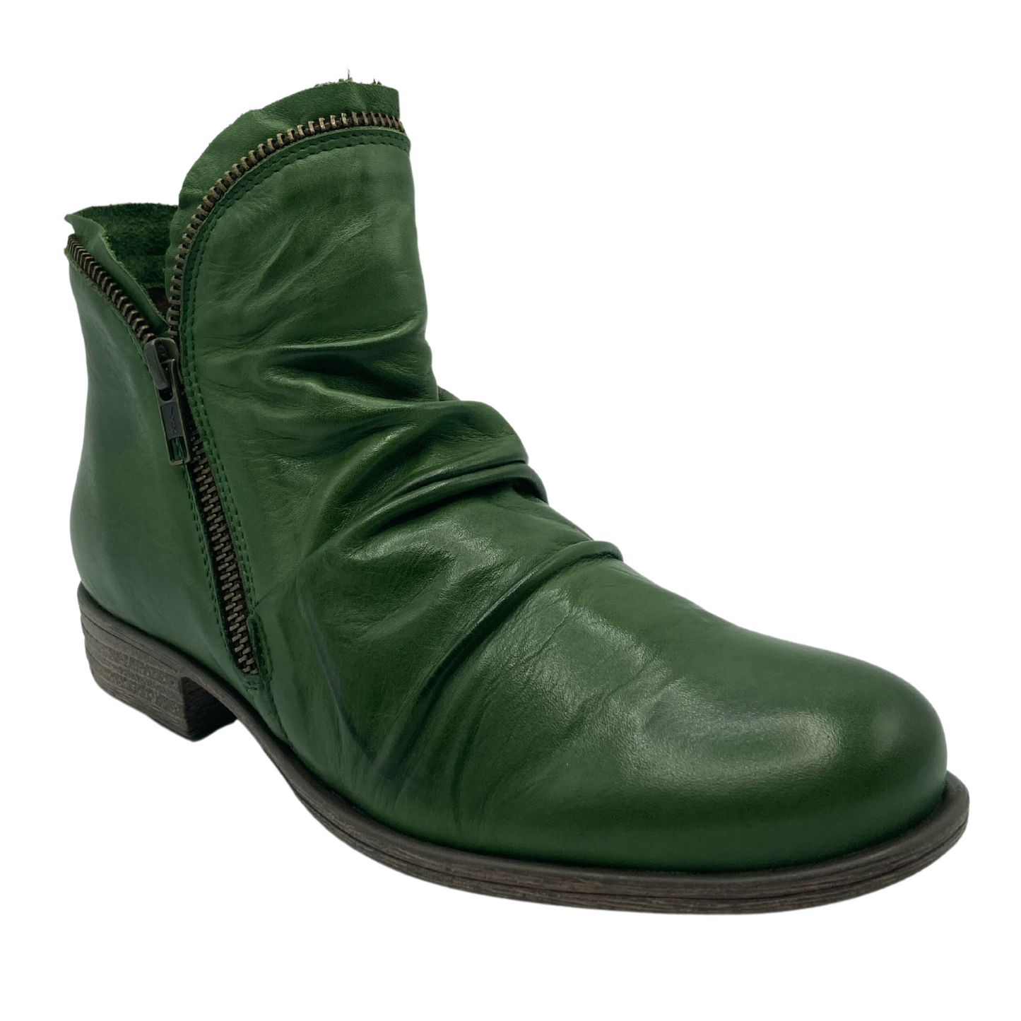 45 degree angled view of slouchy, green, leather boot with zipper detail