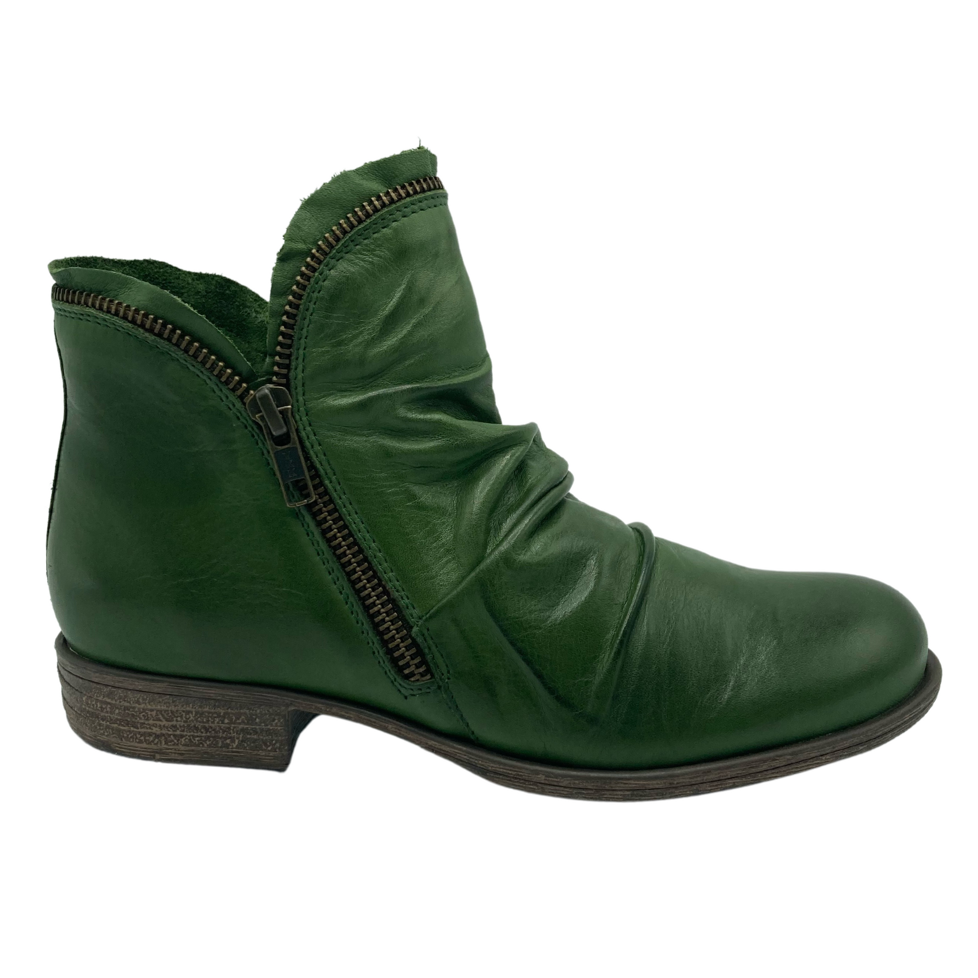 Right facing view of green leather ankle boot with zipper detail and short heel