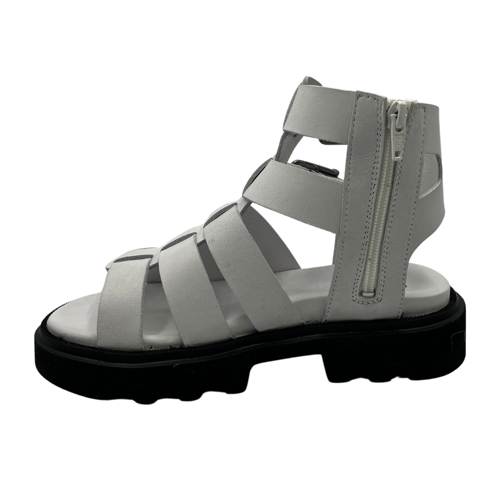 Left facing view of white leather gladiator sandal with black rubber outsole. Lined footbed and double buckle straps