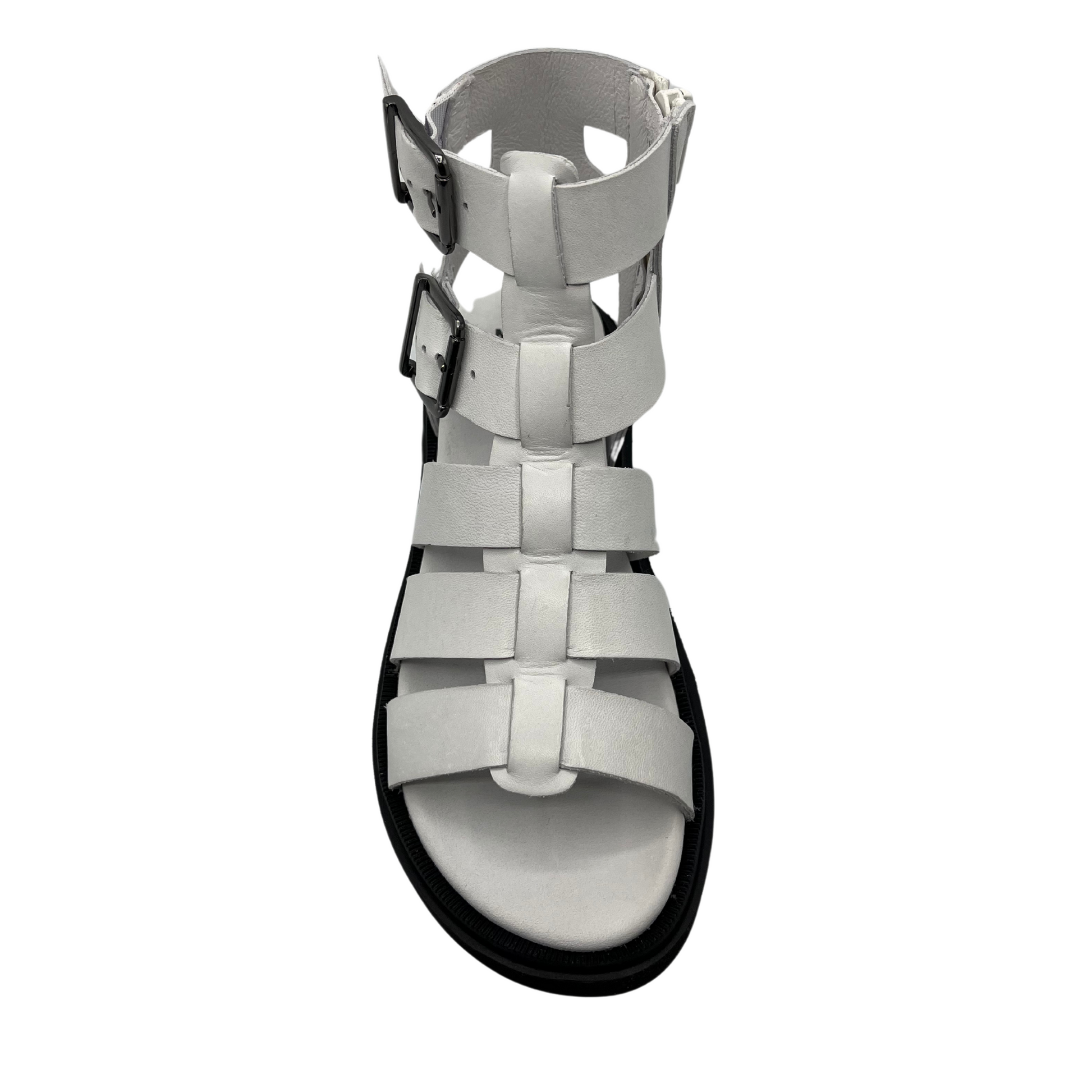 Top view of white leather gladiator sandal with black rubber outsole. Lined footbed and double buckle straps