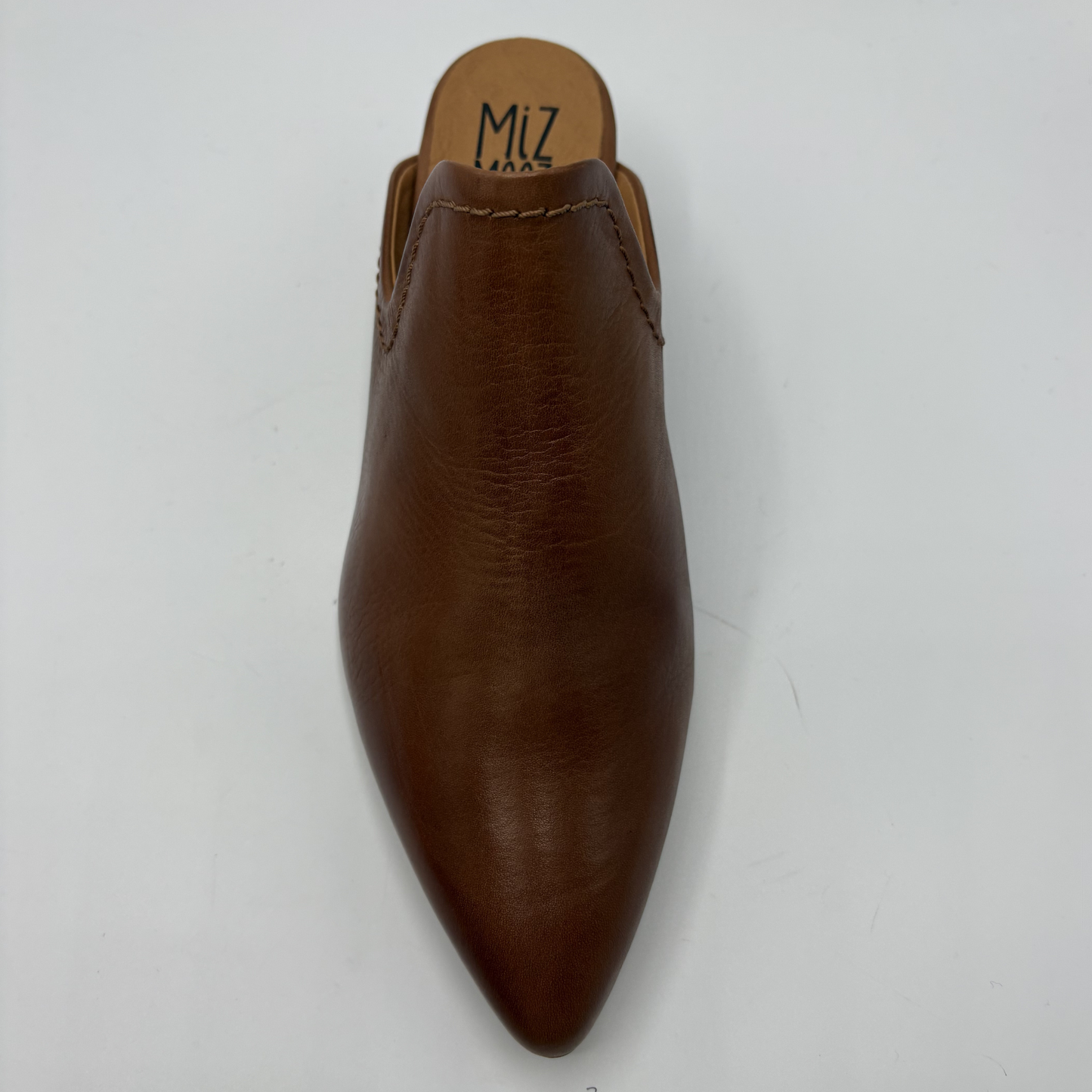 Brown leather shoe with pointed toe on a white background