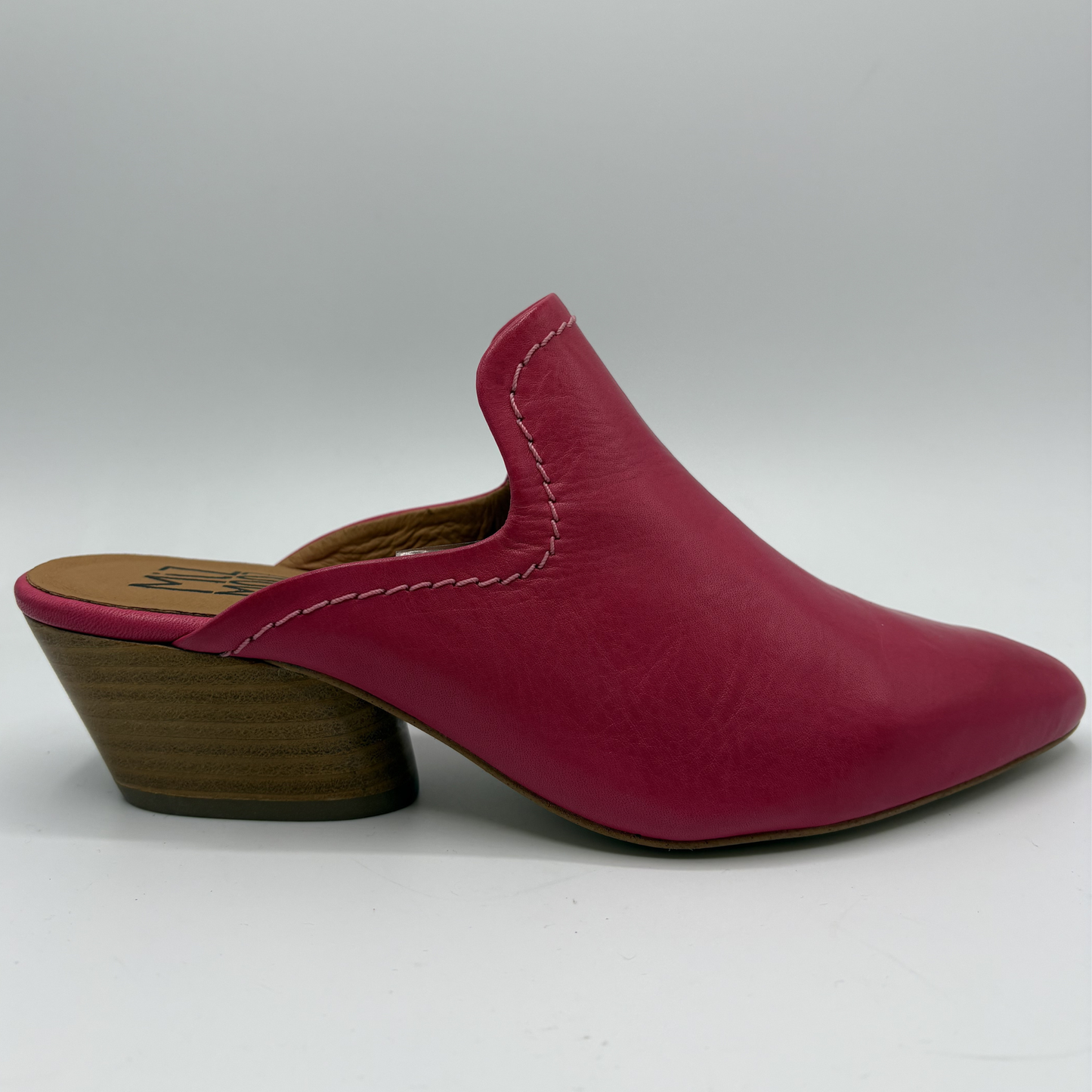 Magenta leather mule shoe on a white background