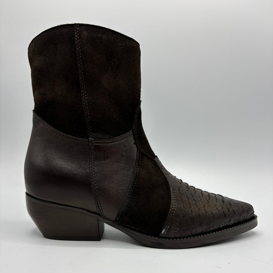 A dark brown western-style ankle boot featuring a mix of smooth leather panels and a textured woven leather toe cap, set against a plain light gray background.