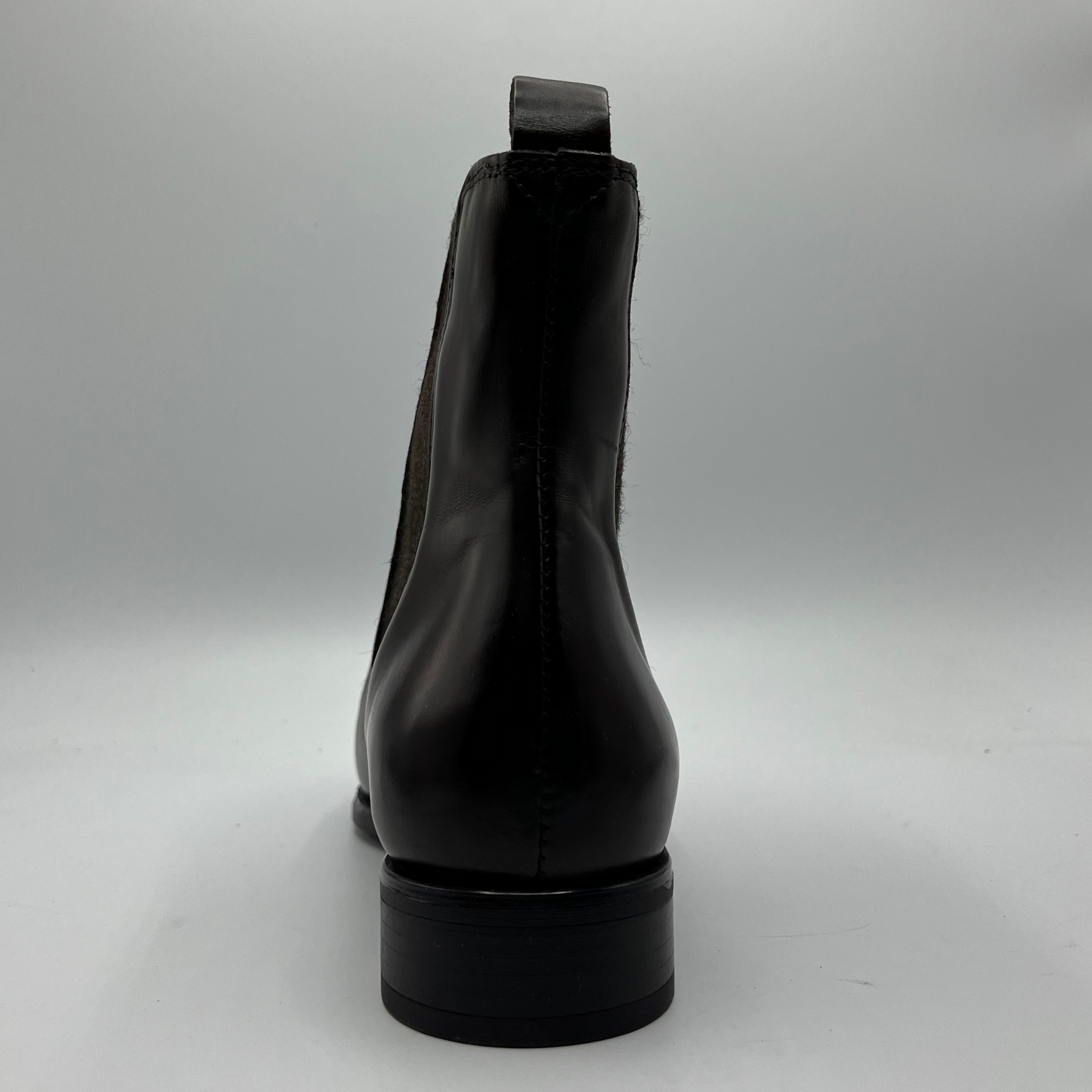 Chestnut leather boot on a gray background