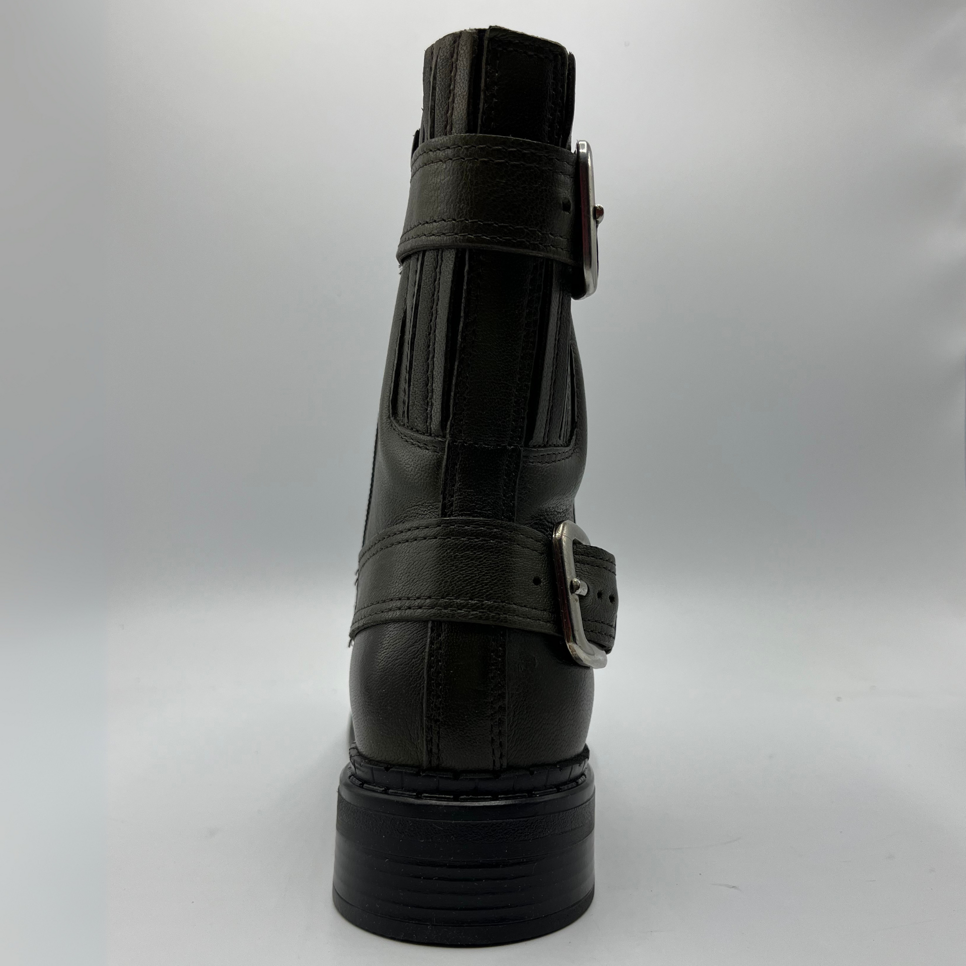 Green leather boot with buckles on a white background