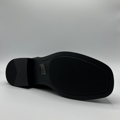 Black boot sole on a gray background