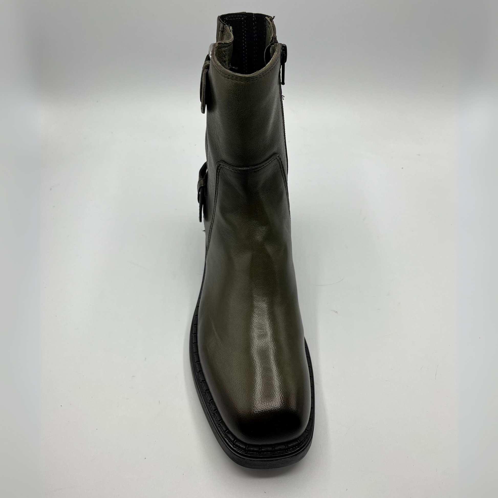 Green leather boot on a white background