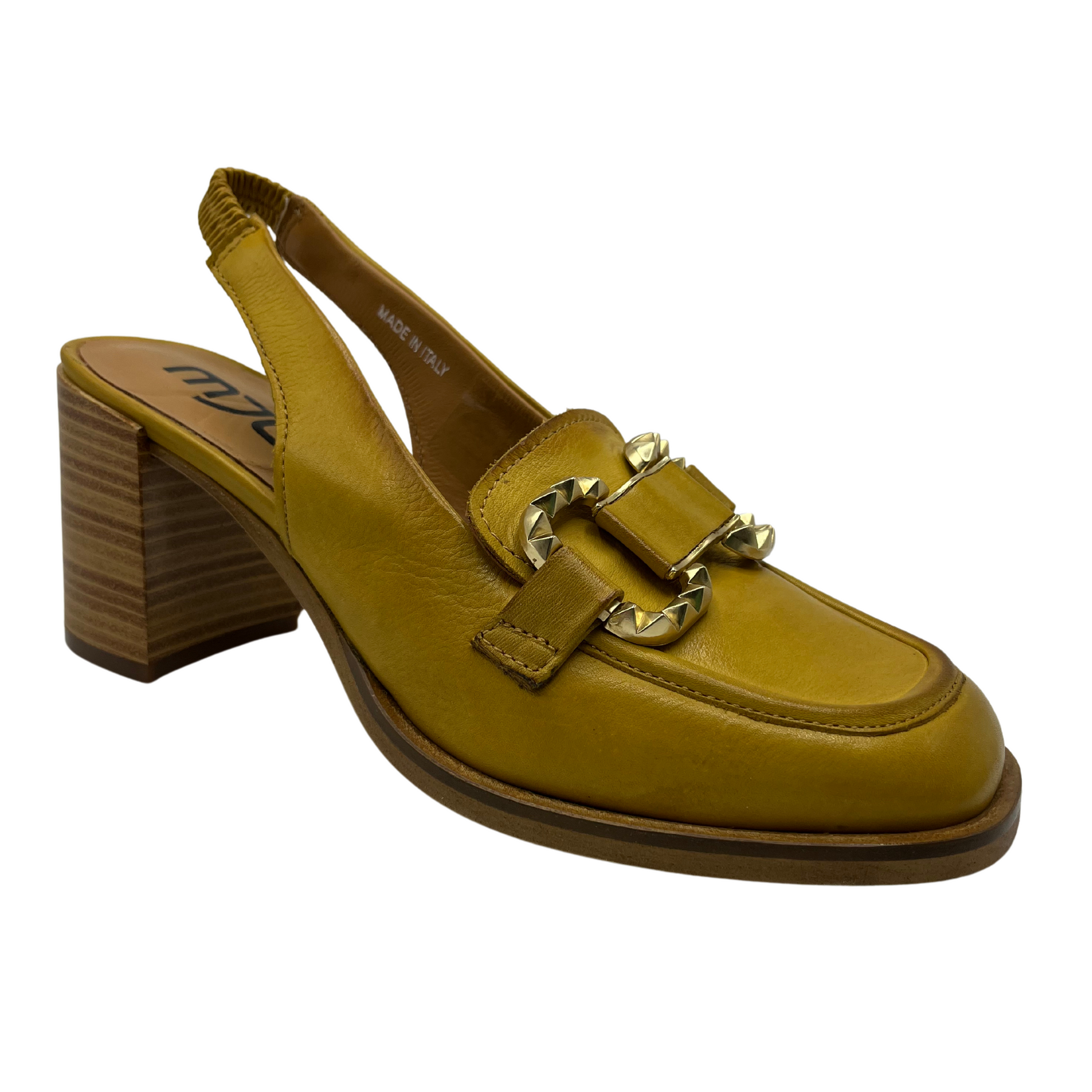45 degree angled view of mustard yellow loafer with block heel and gold detail on toe box. Sling back strap