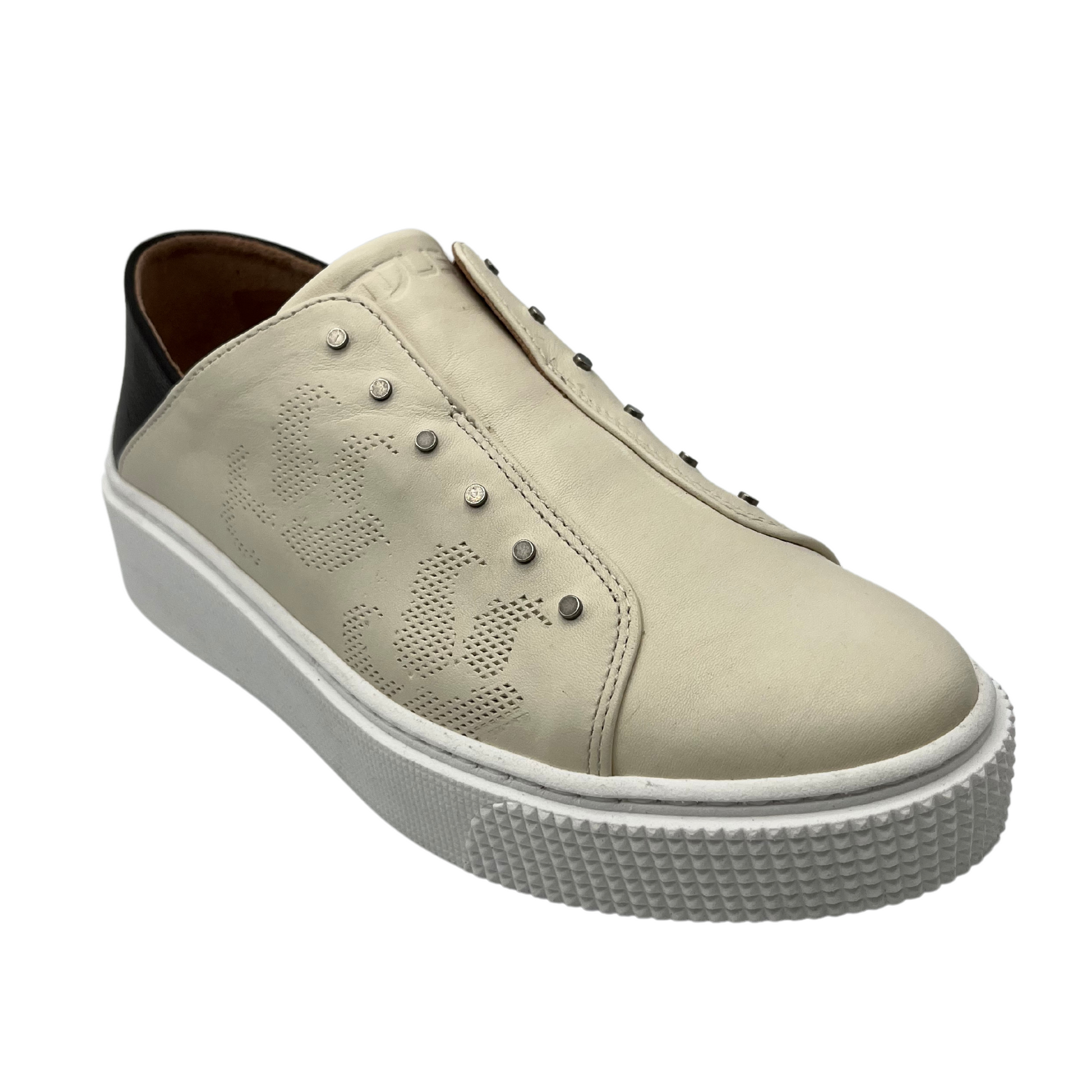 45 degree angled view of latte coloured sneaker with black heel cap