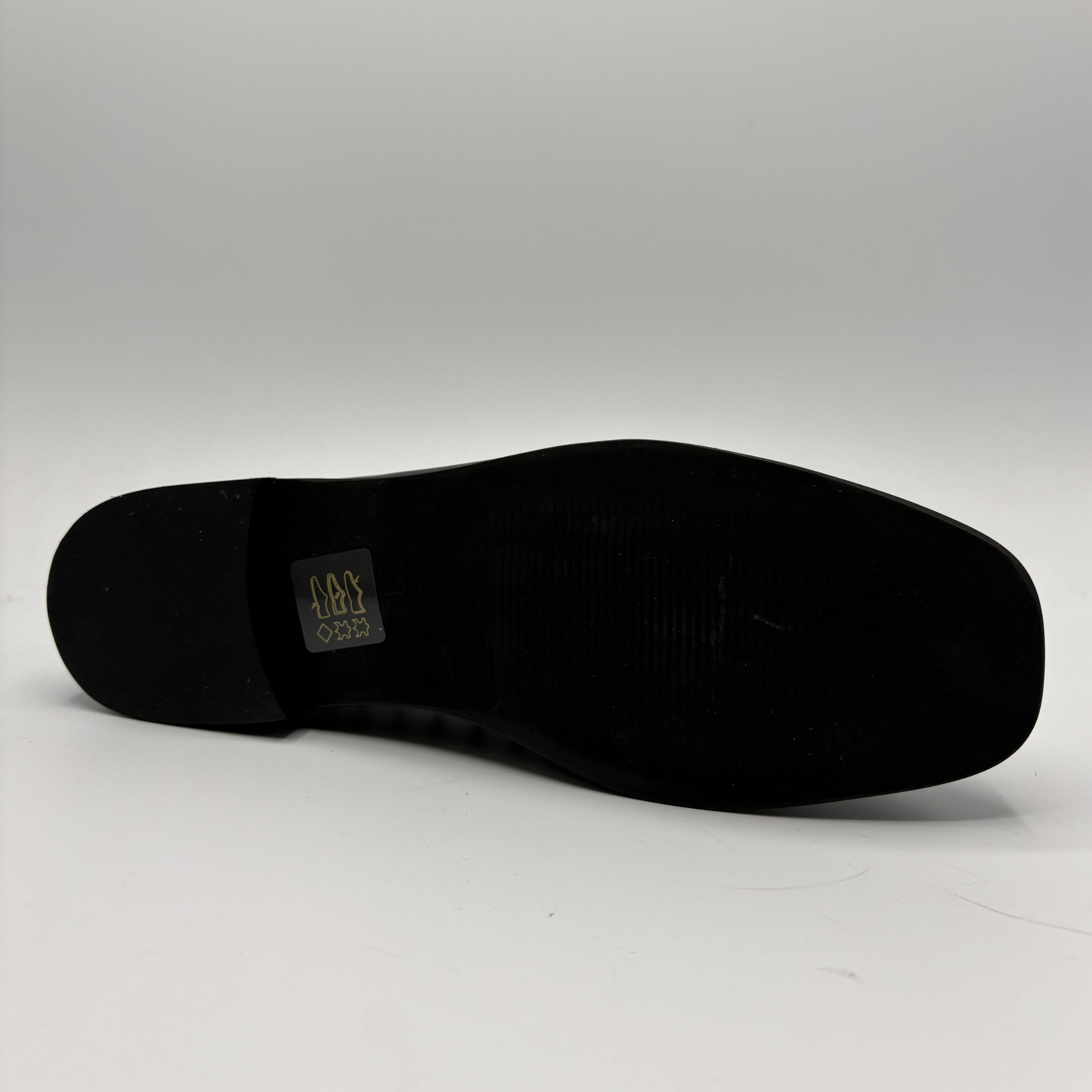 Black shoe sole with a brand logo on a white background