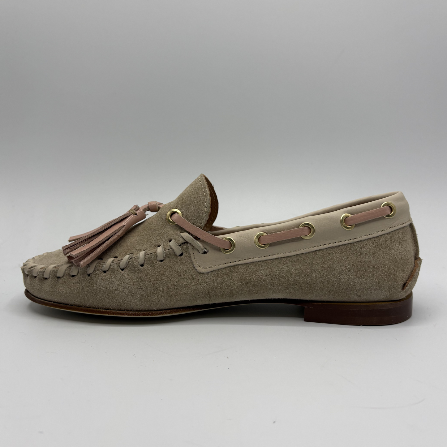 Beige loafer with tassel on a white background