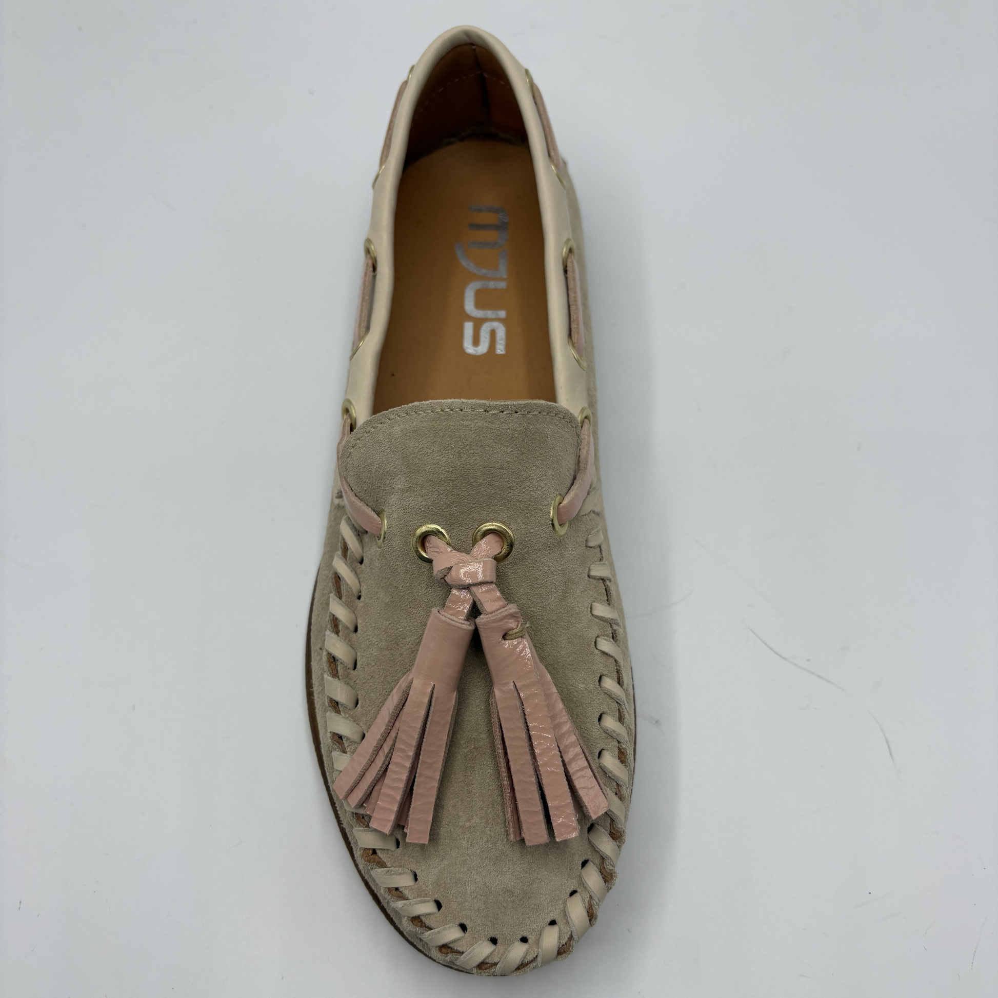 Beige loafer with tassels on a white background