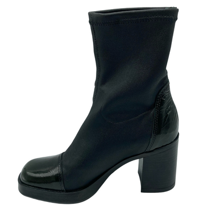Left facing view of chunky black heeled boot