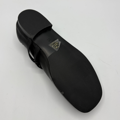 Black shoe sole with a brand logo on a light gray background