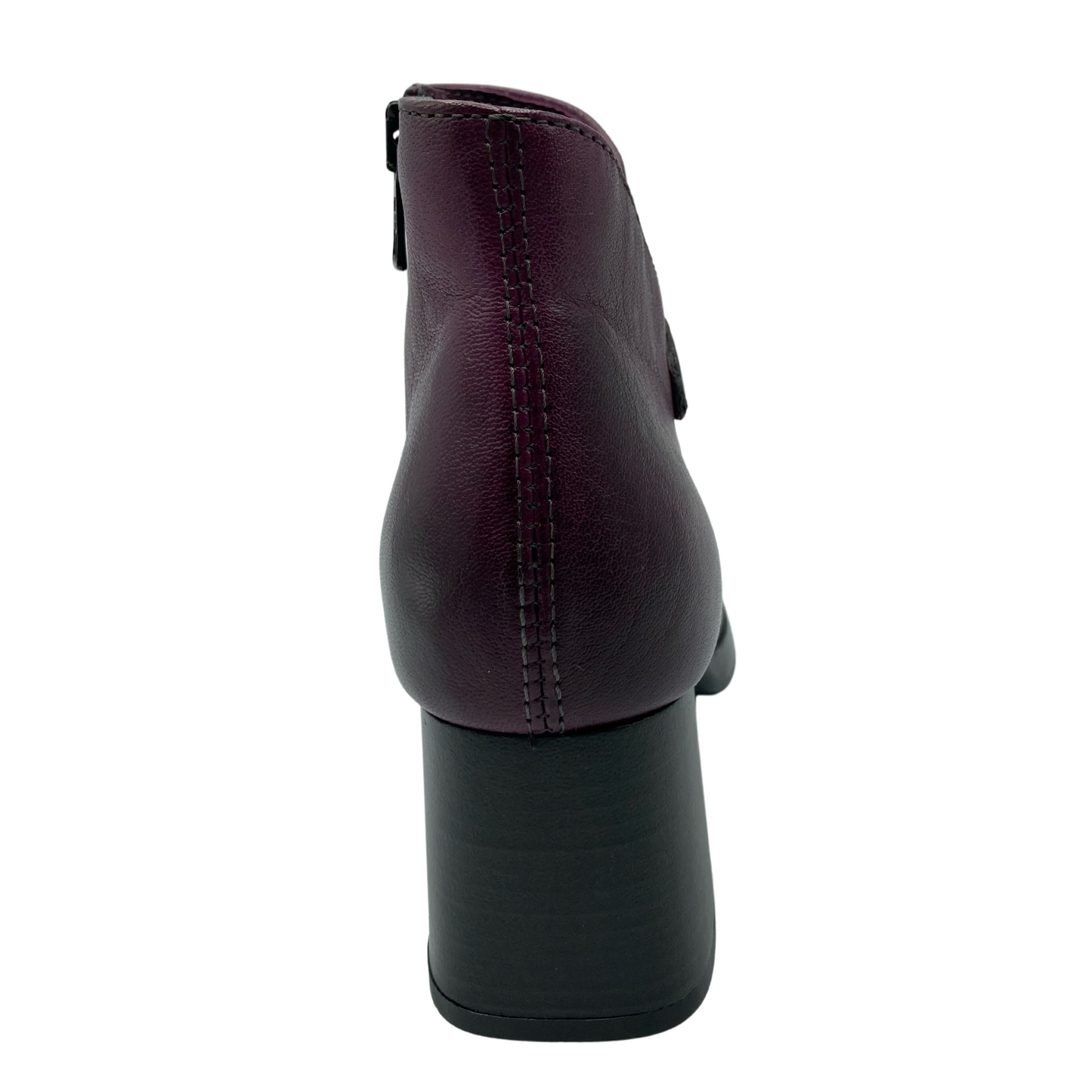 Heel view of purple ankle boot with chunky black heel and stitching detail along the back