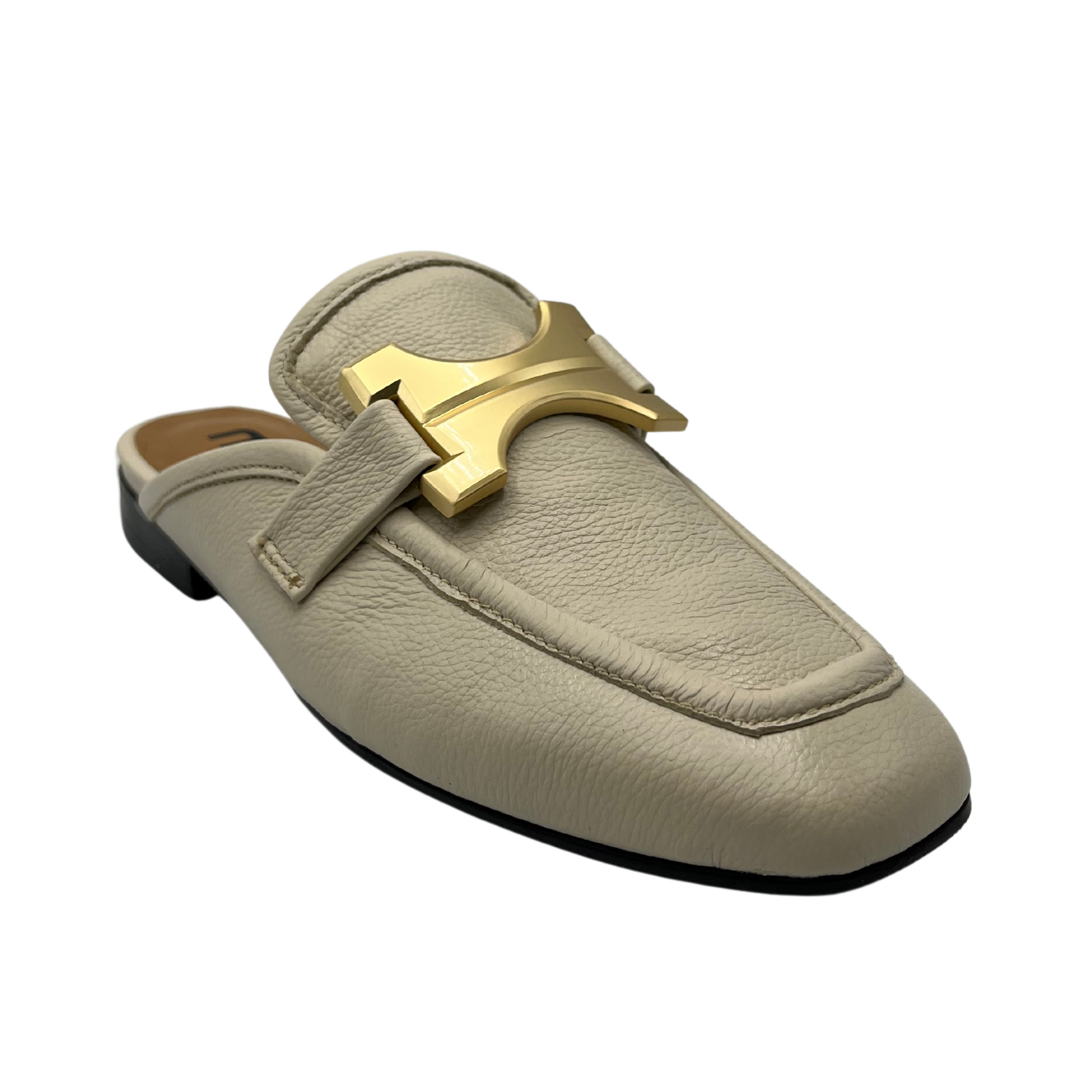 45 degree angled view of latte leather loafer with square toe and gold embellishment