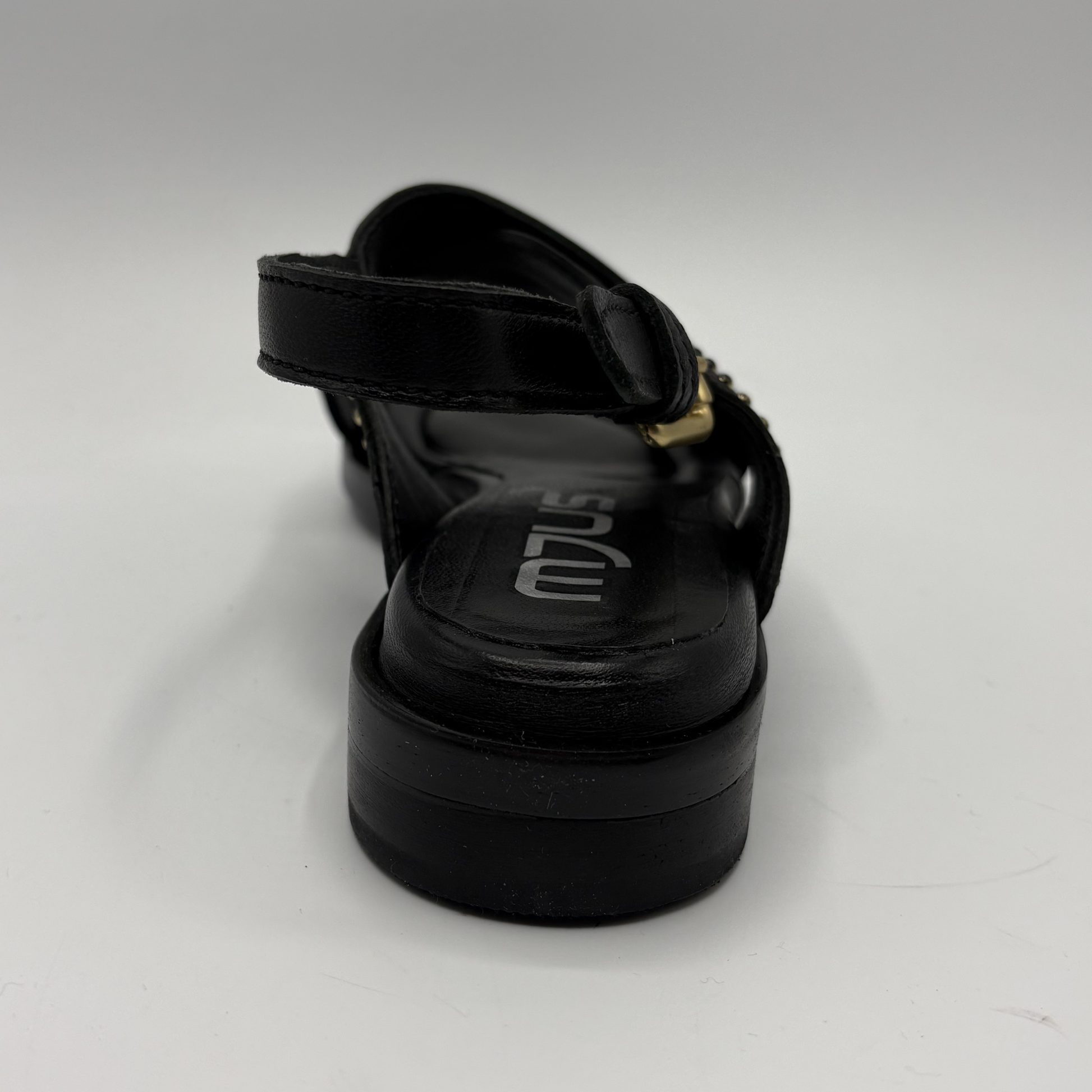 Black sandal with a thick sole on a white background