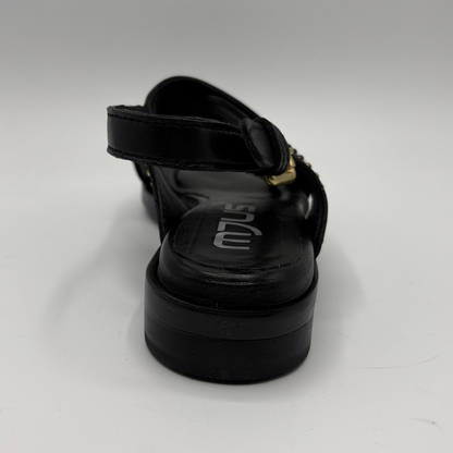 Black sandal with a thick sole on a white background