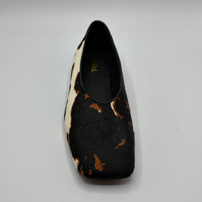 Black and brown patterned shoe on a gray background