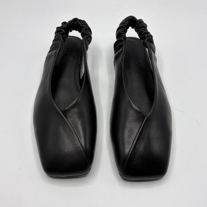 Pair of black leather shoes with a unique design on a white background