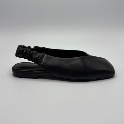 Black flat shoe with a sock-like design on a gray background