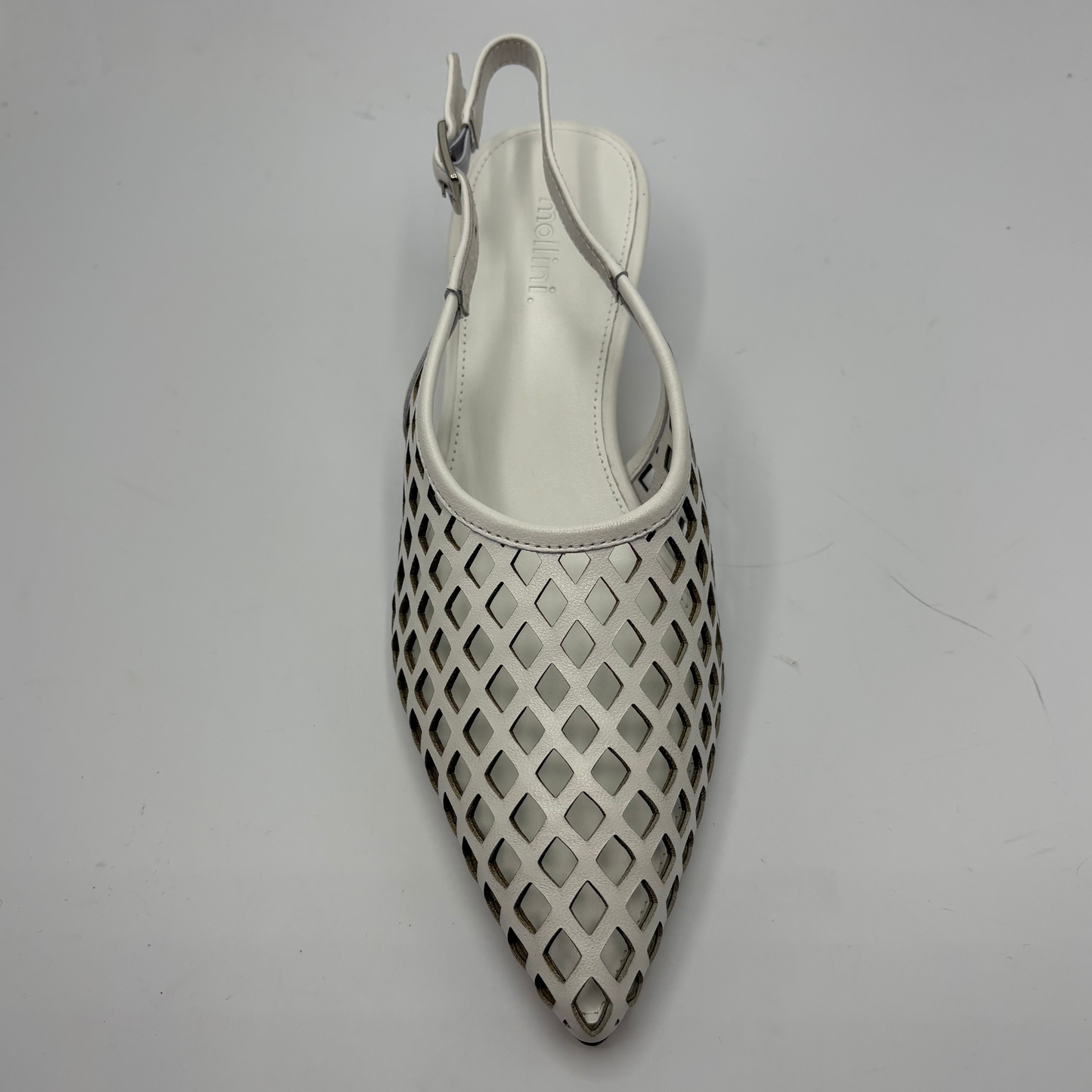 White sandal with perforated design on a gray background