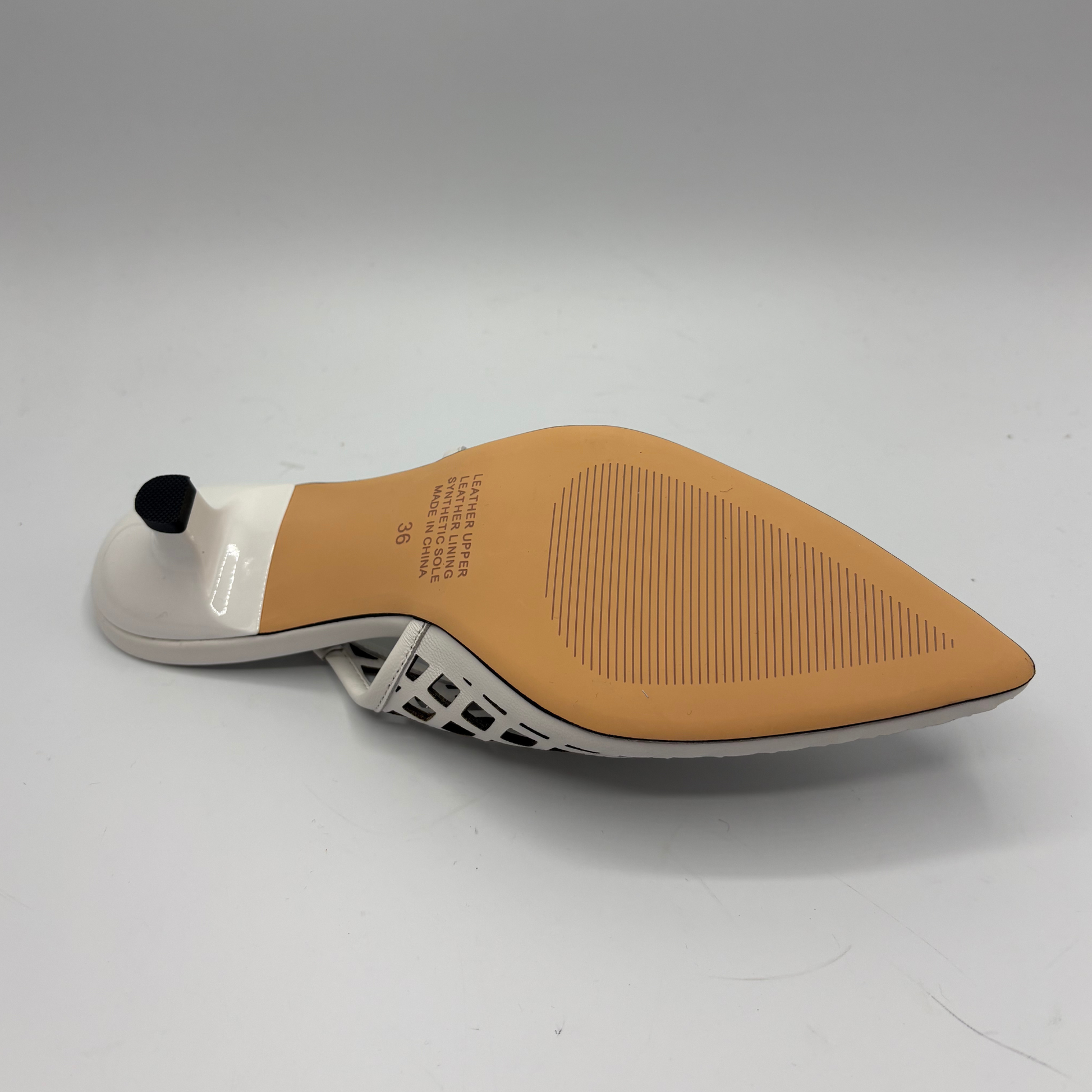Shoe sole with tan rubber outsole and white inner sole on a gray background