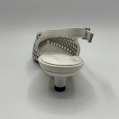 White sandal with a minimalist design on a gray background