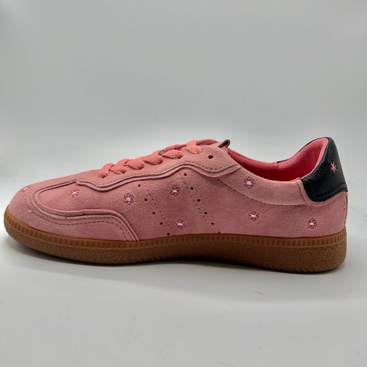 Left facing view of a pink suede sneaker with a black collar and a tan rubber outsole.